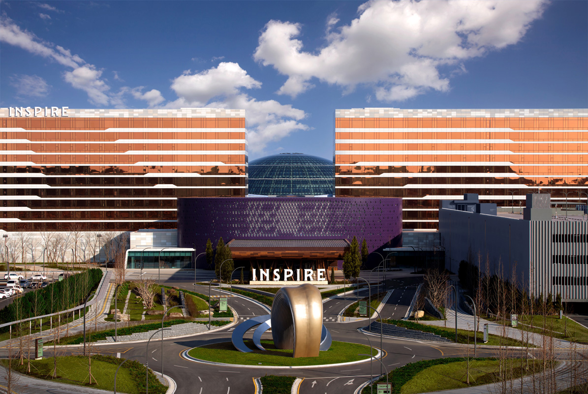 Exterior of INSPIRE Entertainment Resort in Incheon, South Korea, under a blue sky